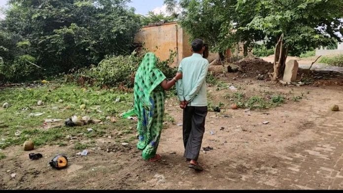 Roopmani Singh, 50, is guided by his wife to the hospital ground where patients go to relieve themselves | Shubhangi Misra | ThePrint