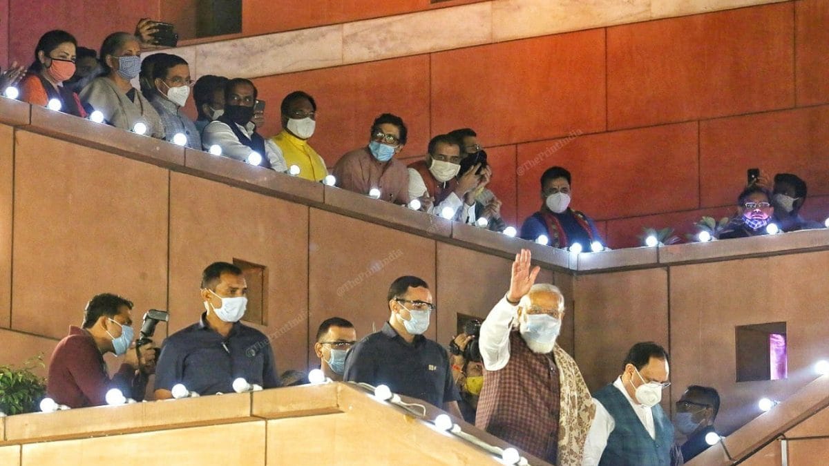 PM Modi walking towards the dais while several cabinet ministers stand on the terrace of the building | Photo: Praveen Jain | ThePrint
