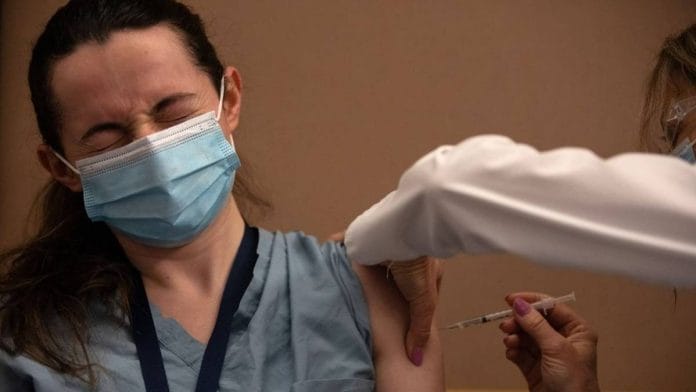 A healthcare worker receives the Pfizer-BioNTech Covid-19 vaccine in Ann Arbor, Michigan, US | Representational image | Bloomberg