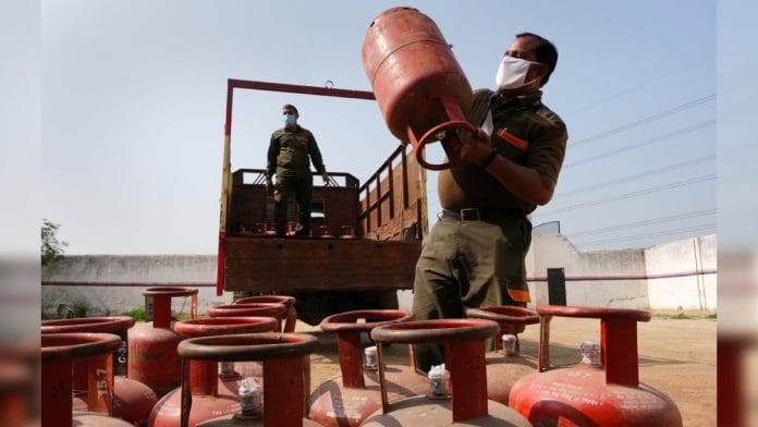 Workers load LPG cylinders onto a delivery truck at a village warehouse in Greater Noida, UP | Photographer: T. Narayan | Bloomberg