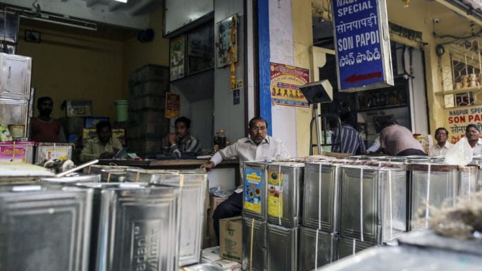 Vendors at a store selling edible oils at Begum Bazaar in Hyderabad, India| Photographer: Dhiraj Singh/Bloomberg