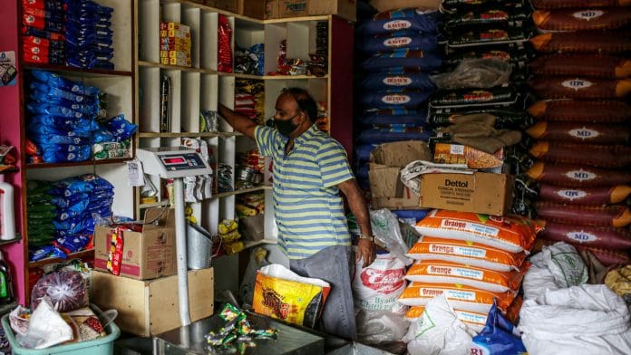 A shopkeeper arranges stock at a grocery store in Bengaluru | Representational image | Bloomberg Photo