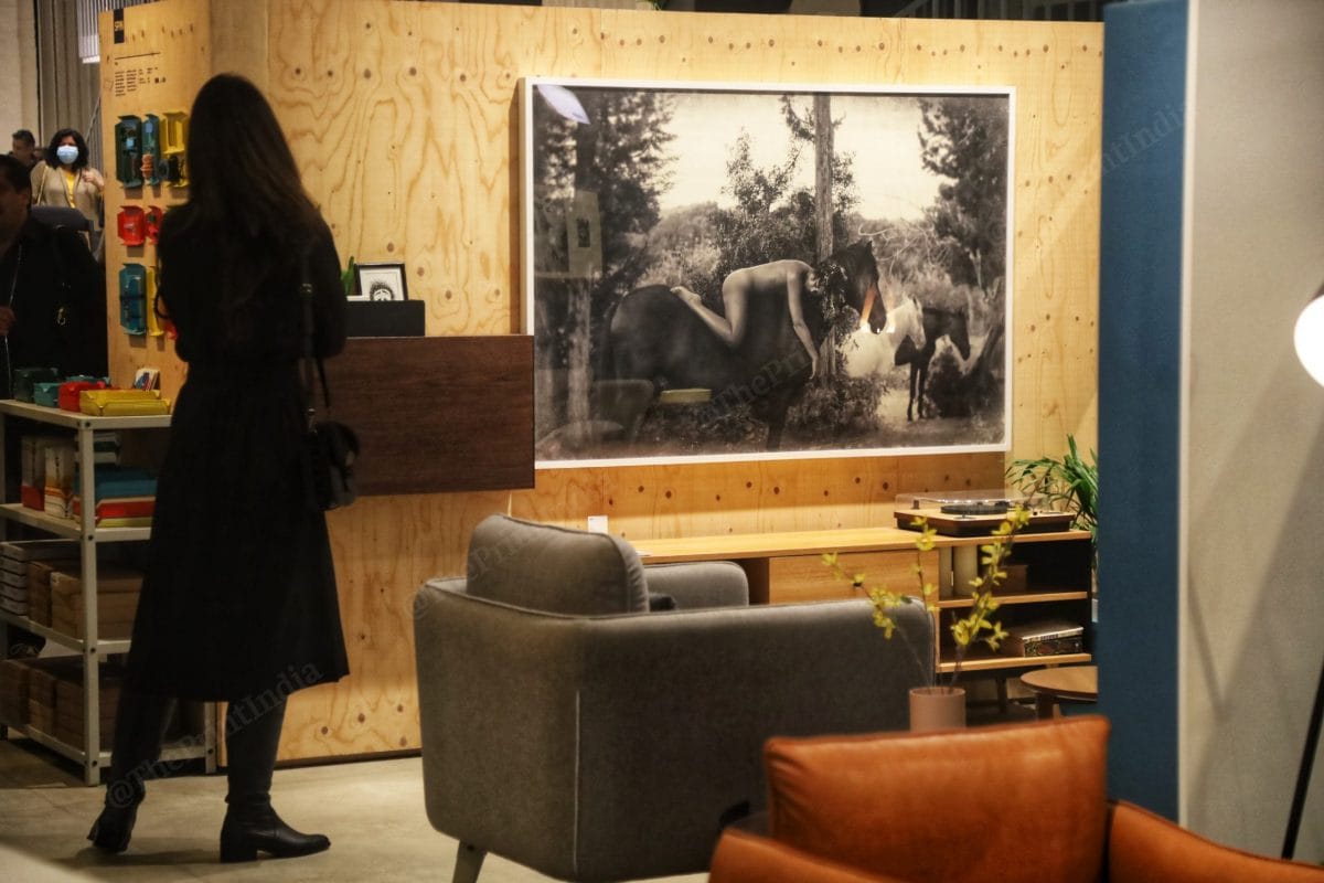 A woman looks at a boudoir picture by Rohit Chawla at the event | Photo: Manisha Mondal | ThePrint