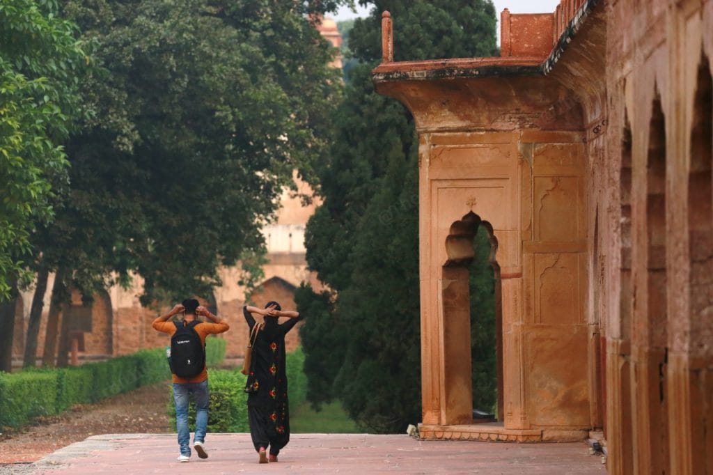 At Safdarjung Tomb a couple walk past the monument | Photo: Manisha Mondal | ThePrint