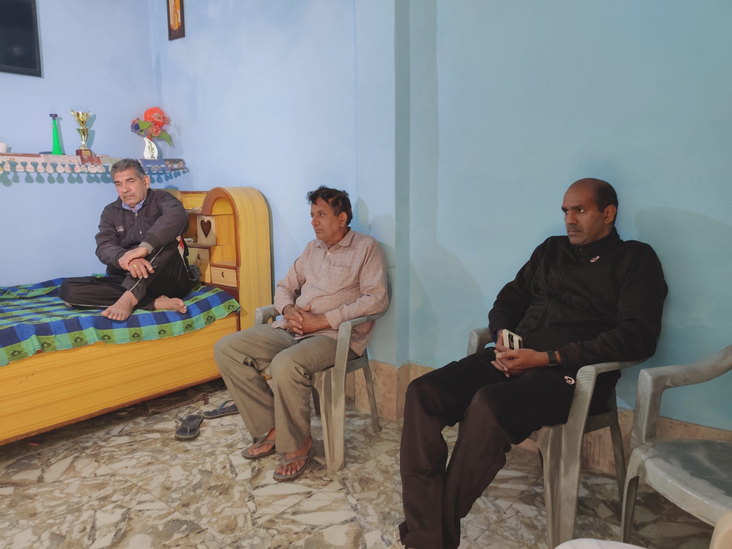Nisha and Sooraj's father Dayanand (seated on bed) at the family's home | Sukriti Vats | ThePrint
