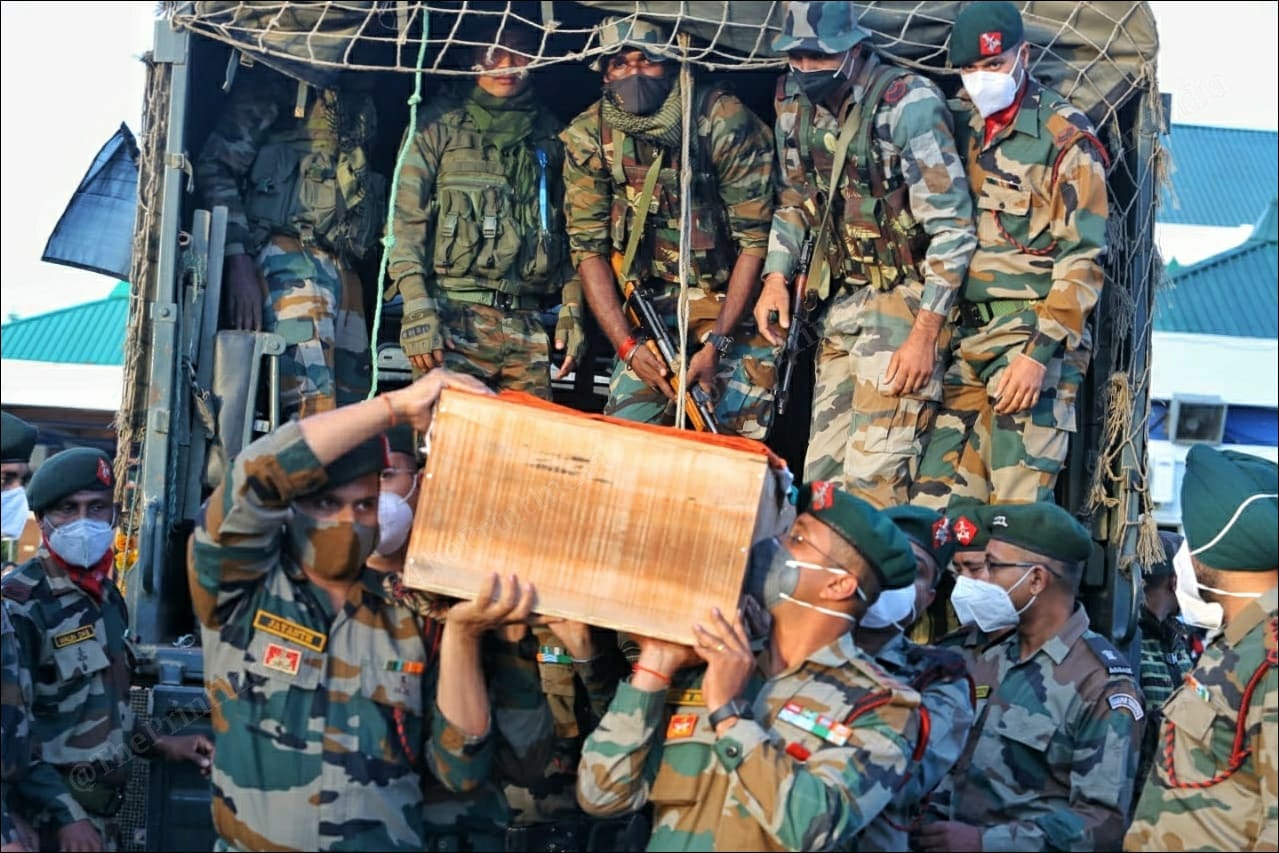Jawans of the Assam Rifles carry the coffins of those who lost their lives in the militant ambush in Manipur | Photo: Praveen Jain | ThePrint