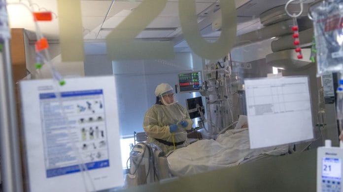 A nurse treating a patient inside the Covid-19 intensive care unit in Vancouver (file photo) | Bloomberg