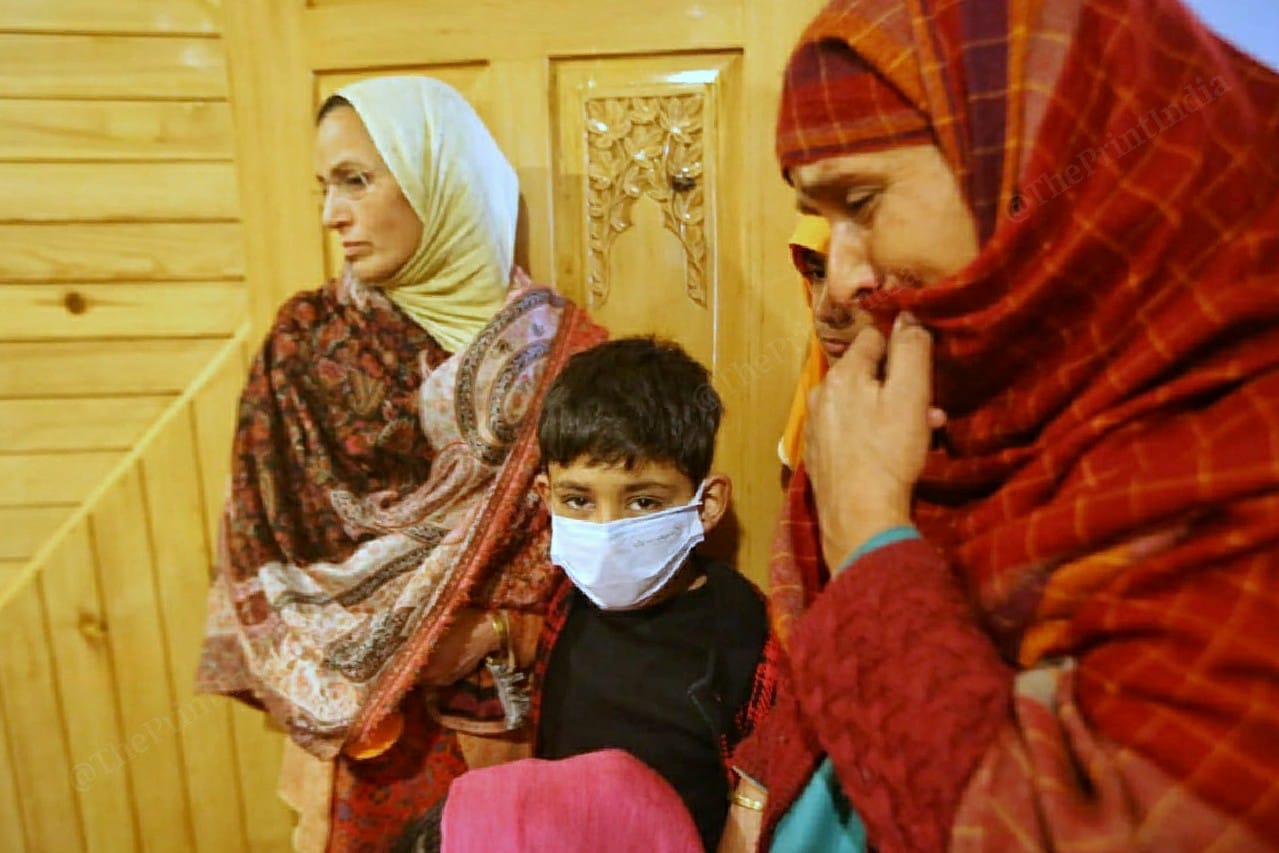 Altaf Bhatt's 7-year-old son Mohammad Ibad with his grieving relatives. | Photo: Praveen Jain/ThePrint
