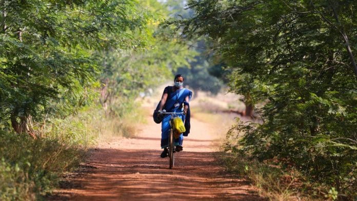 Asha worker Matilda Kullu leaves for work on her cycle | Photo: Manisha Mondal | ThePrint
