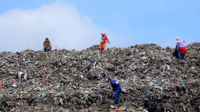 Ragpickers collect recyclable items at a garbage dumping site in Agartala. | File photo: ANI