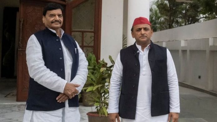 Samajwadi Party chief Akhilesh Yadav with Pragatisheel Samajwadi Party leader Shivpal Singh Yadav, on 16 December 2021