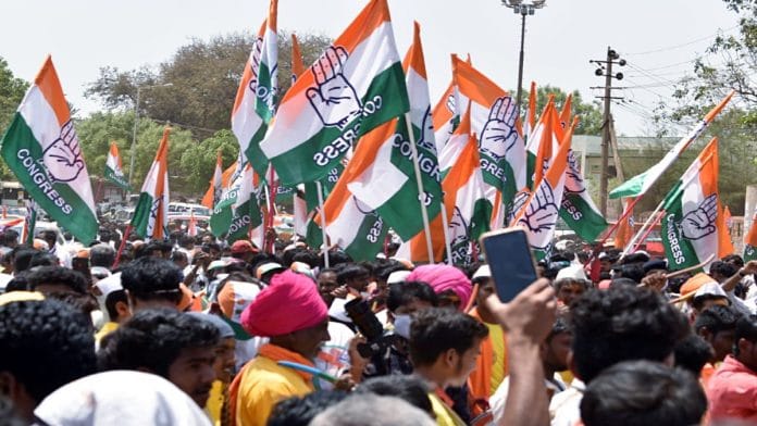 File photo of Congress supporters holding party flags during an election campaign in Basavakalyana | ANI