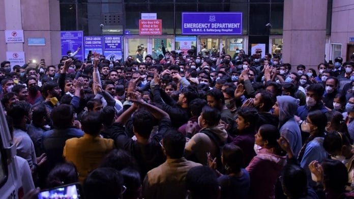 Resident doctors of various hospitals shout slogans during a protest over the delay in NEET-PG counselling, outside the Emergency gate of Safdarjung Hospital, in New Delhi on 27 December 2021. | Photo: ANI