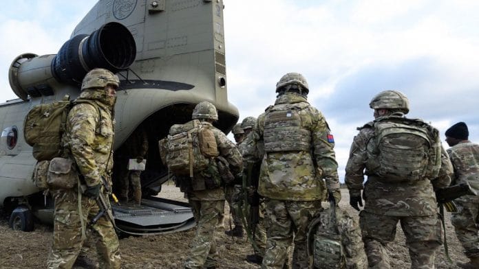 Members of the British Army Royal Irish Battle Group prepare to board a US Army Chinook helicopter to fly to recce a number of locations during pre-exercise integration training on October 27, 2018 in Haslemoen, Norway | Photographer: Leon Neal/Getty Images via Bloomberg