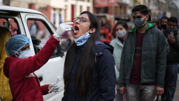 A health worker collects a swab sample for a Covid test in Delhi's Chandni Chowk | Photo: Suraj Singh Bisht | ThePrint