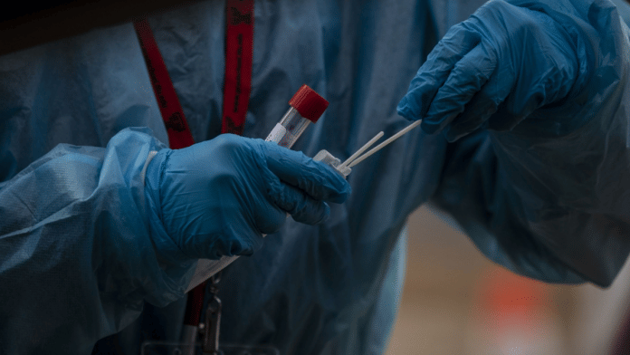 A healthcare worker prepares a Covid swab test at a testing site in Longmont, Colorado, US | Photographer: Chet Strange | Bloomberg