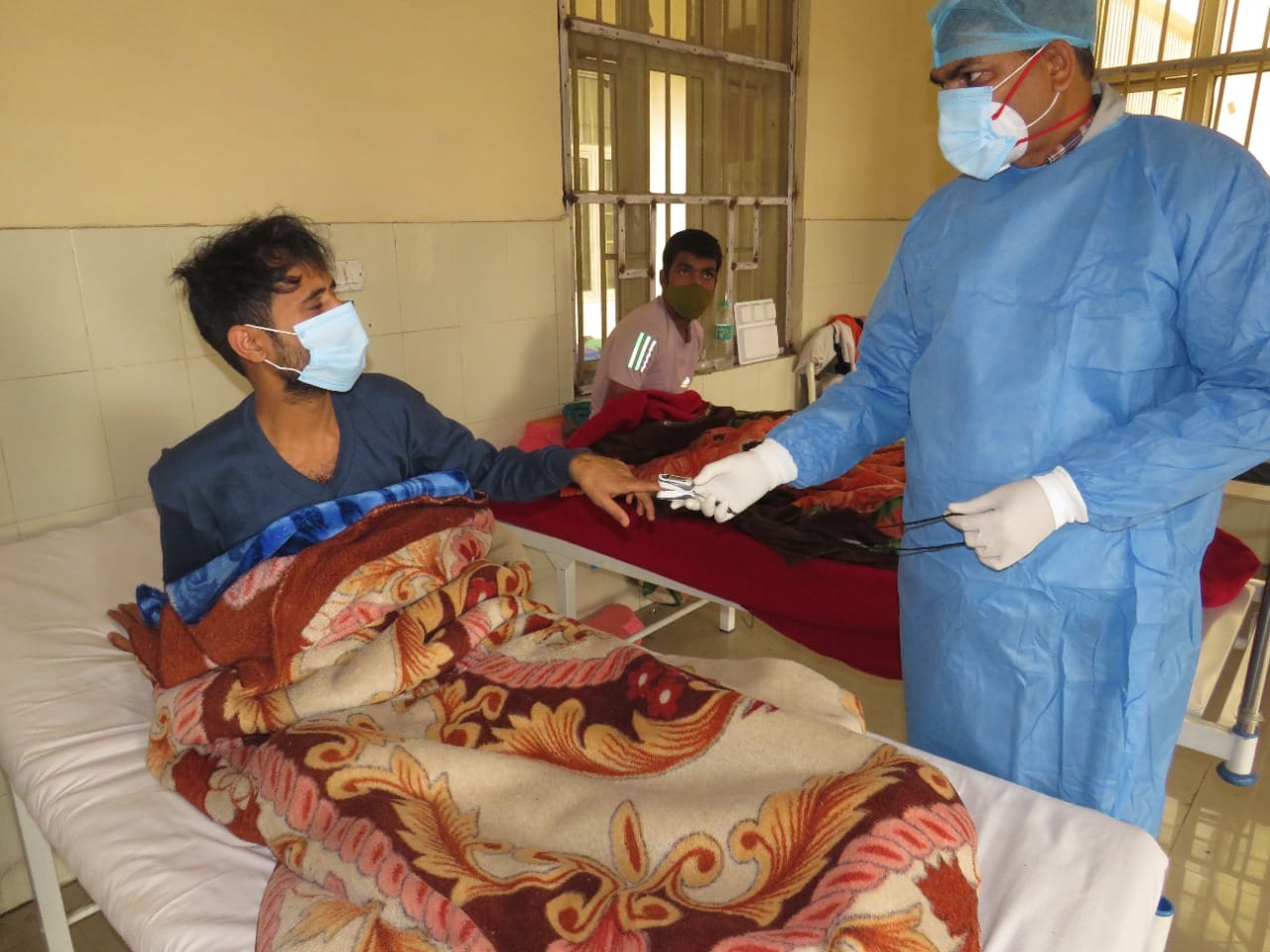 A jail staff member attends a Covid-infected prisoner at Mandoli Jail hospital | By special arrangement