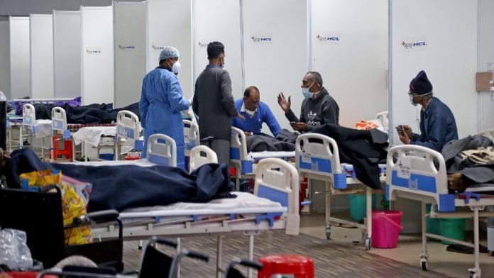 Representational photo of a healthcare worker interacting with Covid patients at an isolation ward in Delhi | ANI