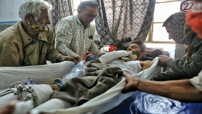RTI activist Amra Ram Godara's father tends to his son at the MDM Hospital in Jodhpur | Photo: Praveen Jain | ThePrint