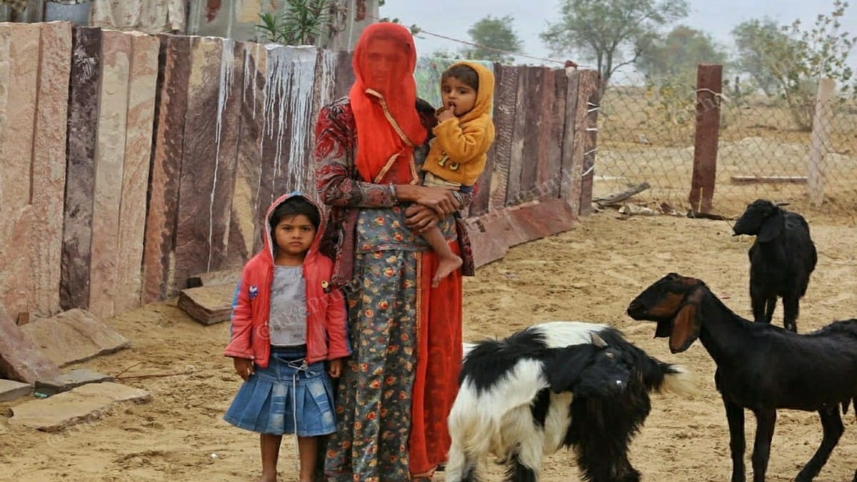 RTI activist Amra Ram Godara's wife Indira Devi with their children outside their home in Jassodon ki Beri village | Photo: Praveen Jain | ThePrint