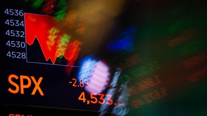 Stock market information on a monitor in the New York Stock Exchange | Bloomberg