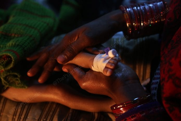 Manju massages her three-month-old son, Rinku, at the Nutrition Rehabilitation Centre in Bahraich | Photo: Manisha Mondal | ThePrint