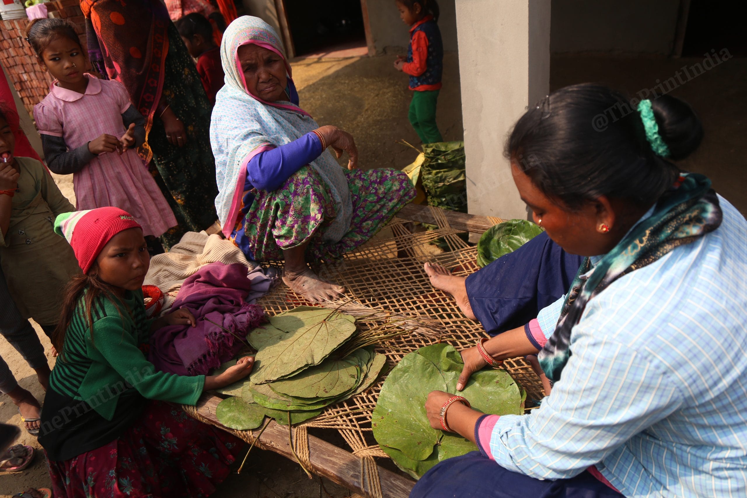 Women in families make plates using leaves. The food in the marriage ceremony will be served in these plates | Photo: Manisha Mondal | ThePrint