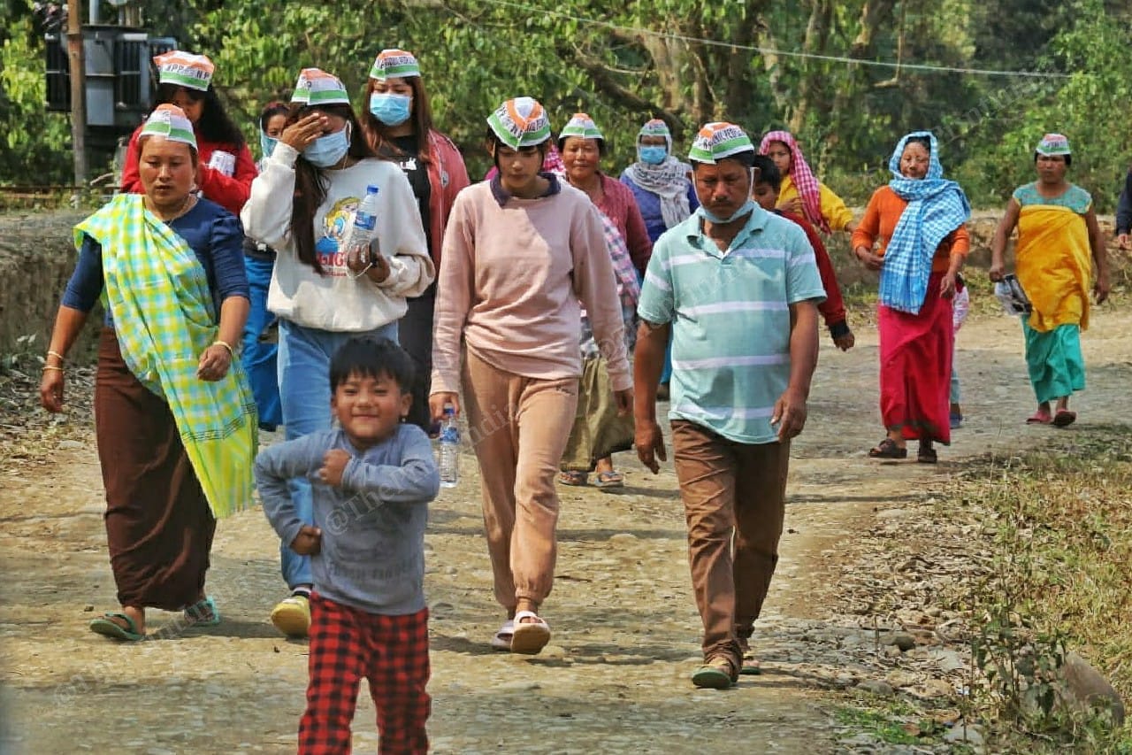 A child dances ahead of NPP Party supporters campaigning for the party's candidate at Kanika village, Imphal | Photo: Praveen Jain | ThePrint