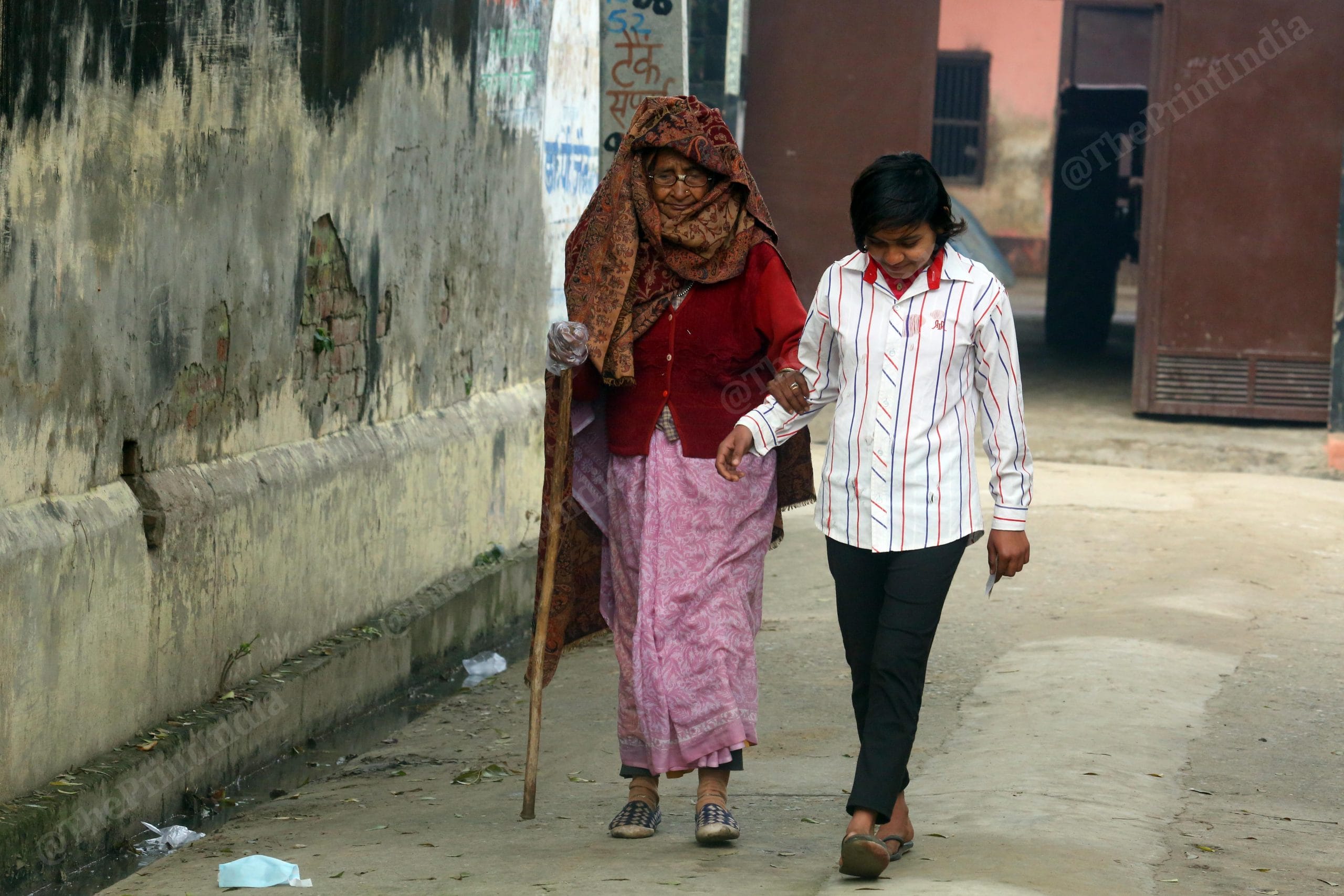 A young girl helps her grandmother to a polling booth in west UP | Praveen Jain | ThePrint