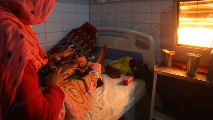 File photo of a mother in UP comforting her malnourished infant | Photo: Manisha Mondal | ThePrint