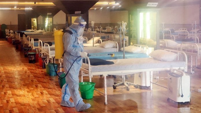 A healthcare worker sanitise a temporarily converted isolation ward for Covid-19 patients in New Delhi, on 30 January 2022 | Representational image | ANI photo