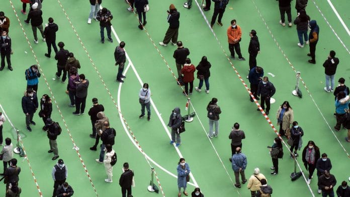 Residents queue at a Covid-19 testing facility in Hong Kong on 23 February 2022 | Photo: Chan Long Hei | Bloomberg