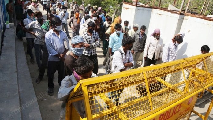 Homeless people and migrant workers stand in queue for food at a shelter home in Delhi | Manisha Mondal | ThePrint