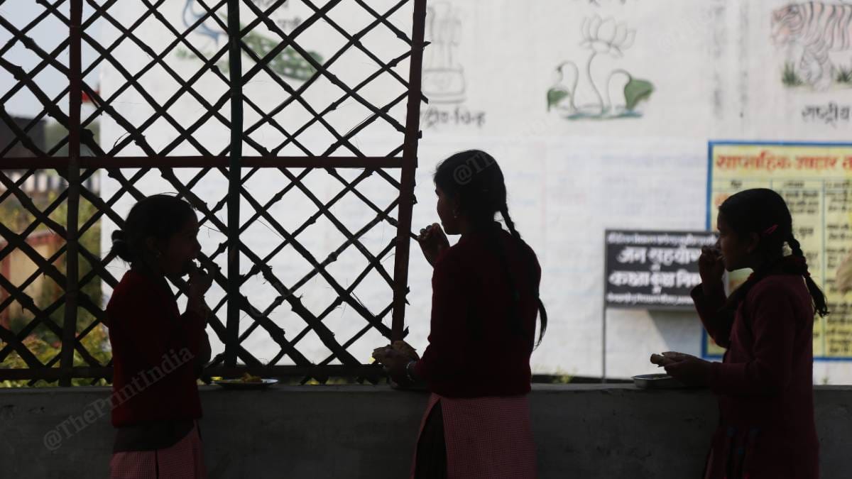 Students having midday meal at the school in Pandey Purwa village | Photo: Manisha Mondal | ThePrint