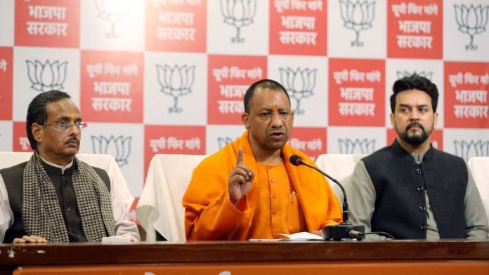 UP CM Yogi Adityanath addresses the press with Union minister Anurag Thakur (R) and deputy CM Dinesh Sharma in Lucknow on 3 February.