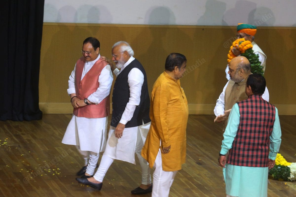PM Modi leaves the dais with J.P. Nadda after the garlanding | Photo: Praveen Jain | ThePrint