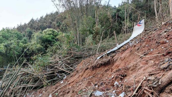 This photo taken on 21 March 2022 shows fragments of wreckage of the China Eastern passenger jet which crashed onto a mountainside in China's southern Guangxi region | Photographer: CNS/AFP/Getty Images via Bloomberg