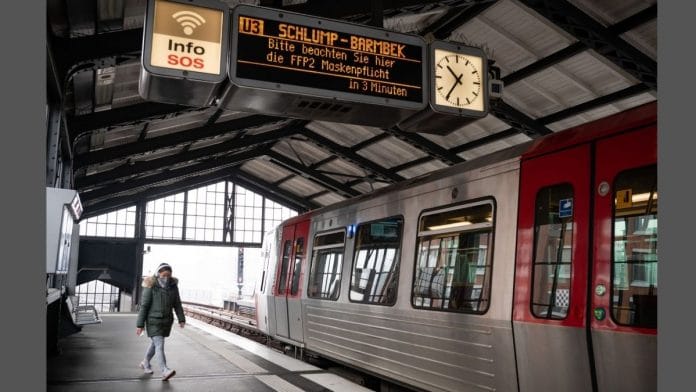 A sign informs passengers that protective mask are obligatory, at a platform in a metro station in Hamburg, Germany, on 15 March 2022 | Bloomberg