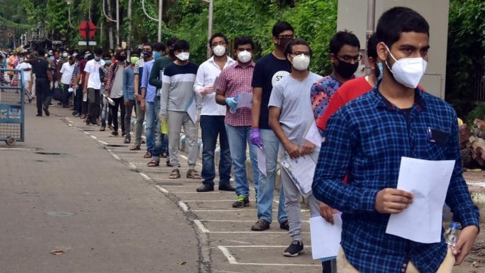 File photo | Examinees stand in a queue maintain social distancing before the JEE examination at an exam center in Kolkata | ANI photo