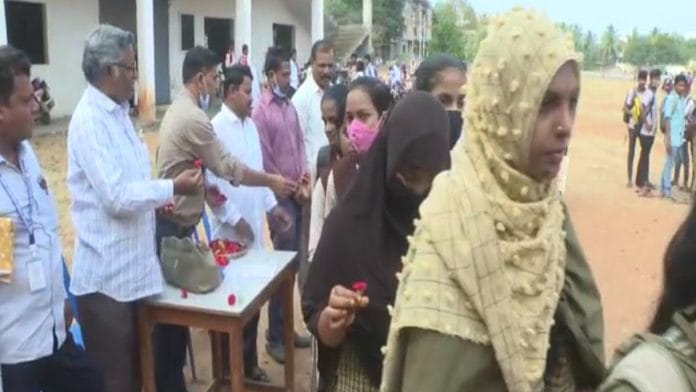 At a school in Karnataka's Gadag district Monday, authorities hand out flowers to Class 10 students ahead of the state board exams | By special arrangement