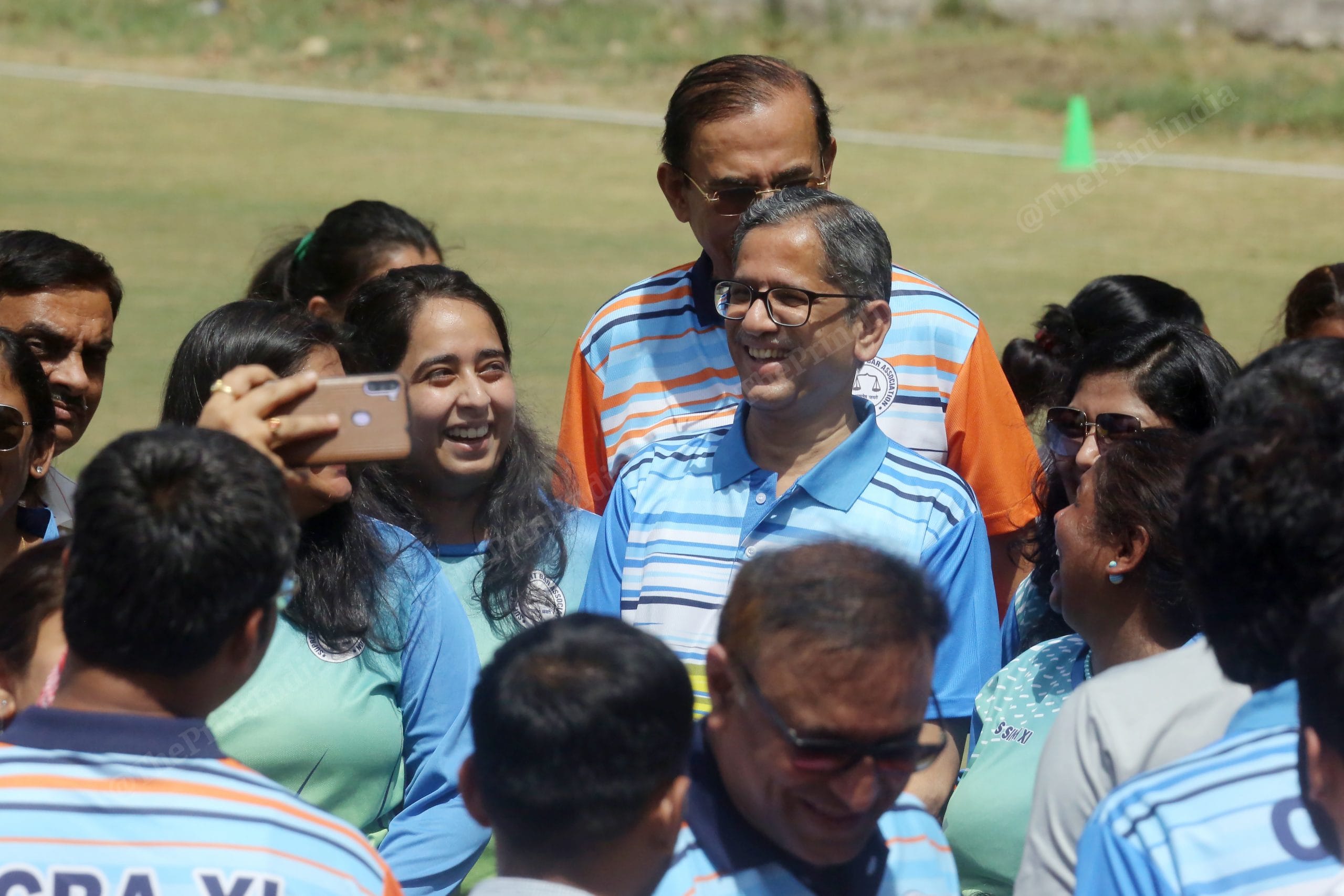 Chief Justice of India N.V. Ramana surrounded by players of the women lawyers' cricket team at Modern School, Barakhamba Road | Photo: Praveen Jain | ThePrint