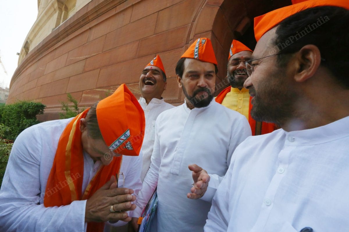 Delhi BJP leader Manoj Tiwari greets Union Minister Anurag Thakur and G. Kisan Reddy outside Parliament on BJP's Foundation Day at Parliament Annexe | Photo: Praveen Jain | ThePrint