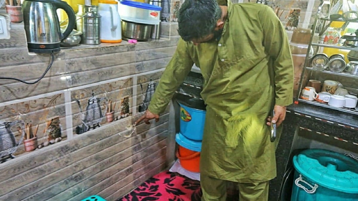 Raja pointing to the bullet marks | Praveen Jain | ThePrint