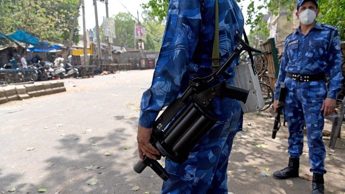Rapid Action Force personnel stand guard at a site where violence erupted between two groups during a Hanuman Jayanti procession, at Jahangirpuri, in New Delhi on 19 April 2022 | ANI Photo