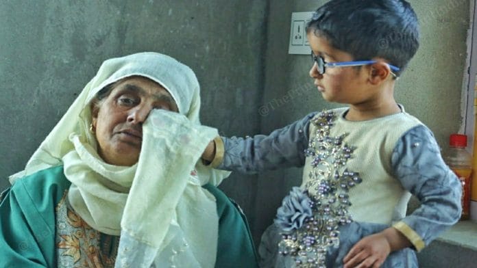 Jana Begum is consoled by a child at her home in Chattabugh village in J&K's Budgam | Praveen Jain | ThePrint