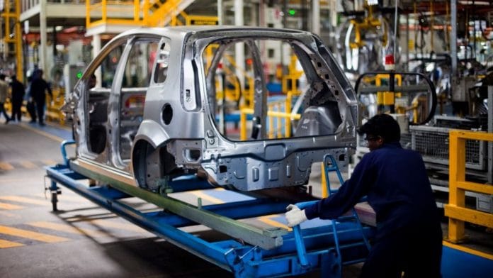 A Ford Motor employee pushes the chassis of an unfinished vehicle at the company's factory on the outskirts of Chennai | File photo | Bloomberg