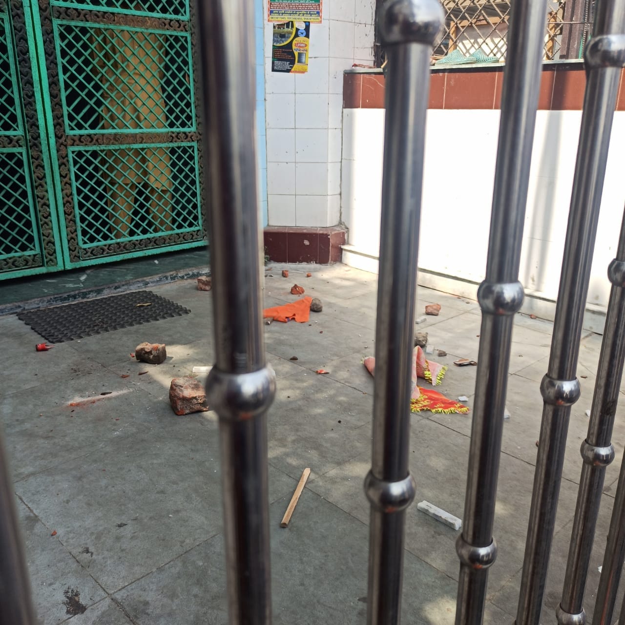 Flags, bricks and wooden sticks seen at the entrance of the mosque in C Block | Gautamee Hazarika | ThePrint