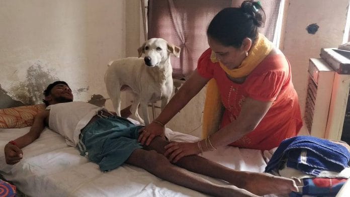 Deepak Roshan with his mother and dog at their Ghaziabad home | Photo: Sonal Matharu | ThePrint