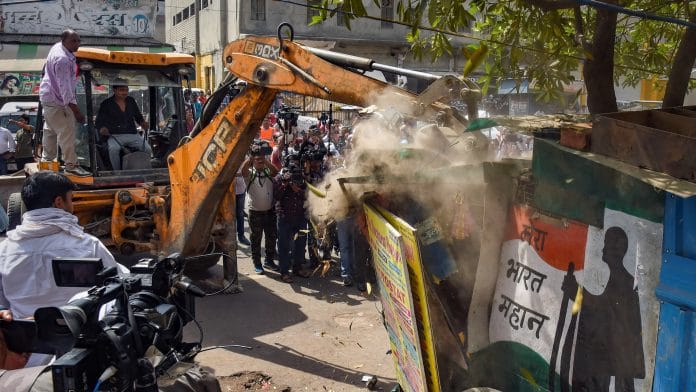 Bulldozers removing illegal structures during an anti-encroachment drive in Jahangirpuri area, in New Delhi, on 20 April 2022 | PTI Photo