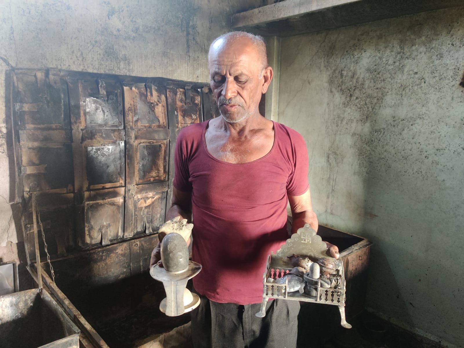 Pannalal Chandore holds a burnt shivling, asking how many more riots will he have to witness. | Photo: Bismee Taskin | ThePrint
